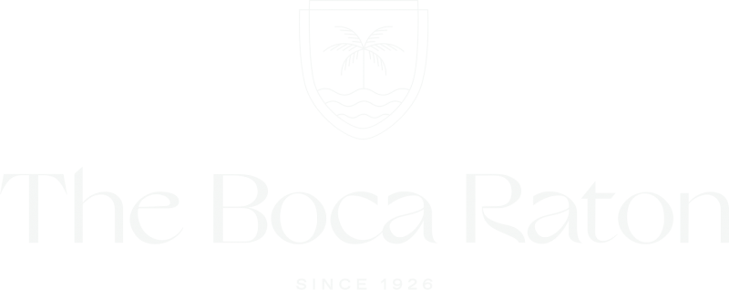 The logo for The Boca Raton in white.